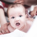 topless baby on bed