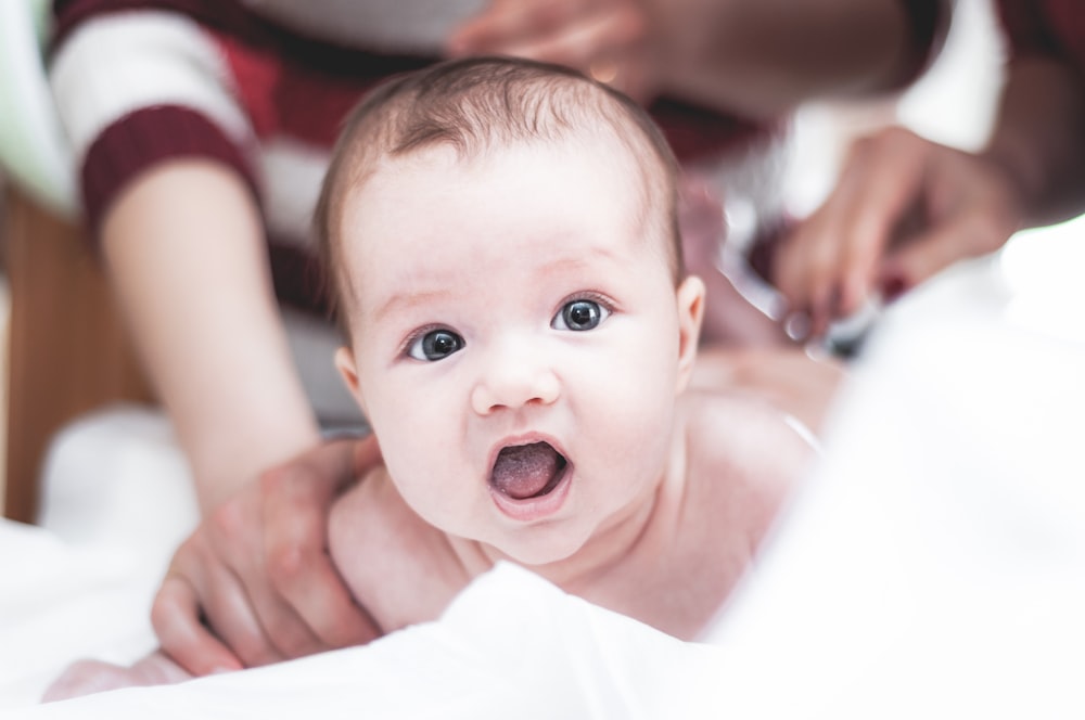 topless baby on bed