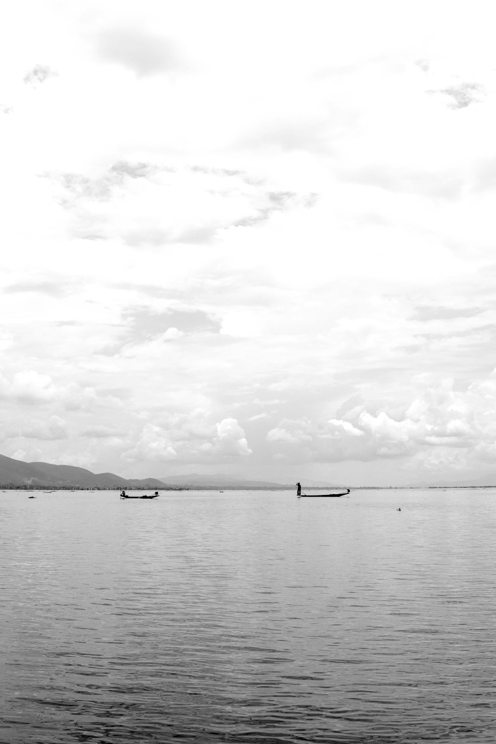 clear blue sea under gloomy sky