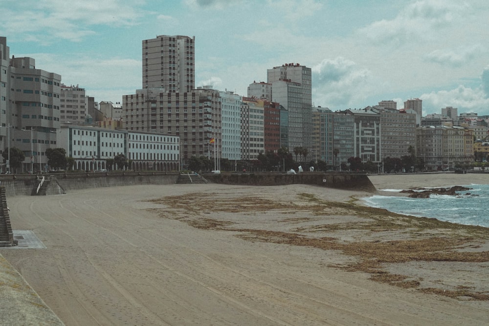 grey concrete buildings near body of water during daytime