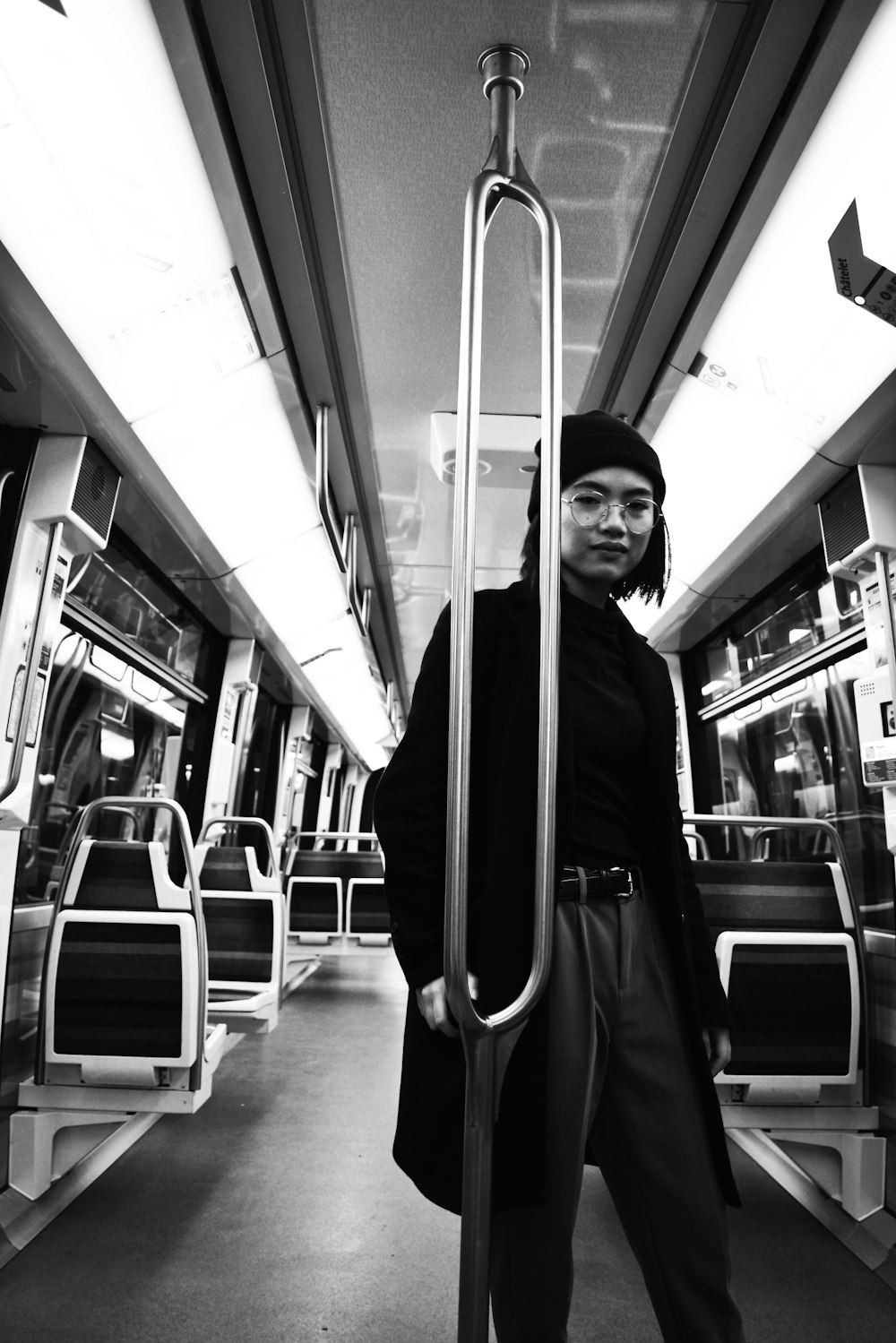 greyscale photo of woman in train