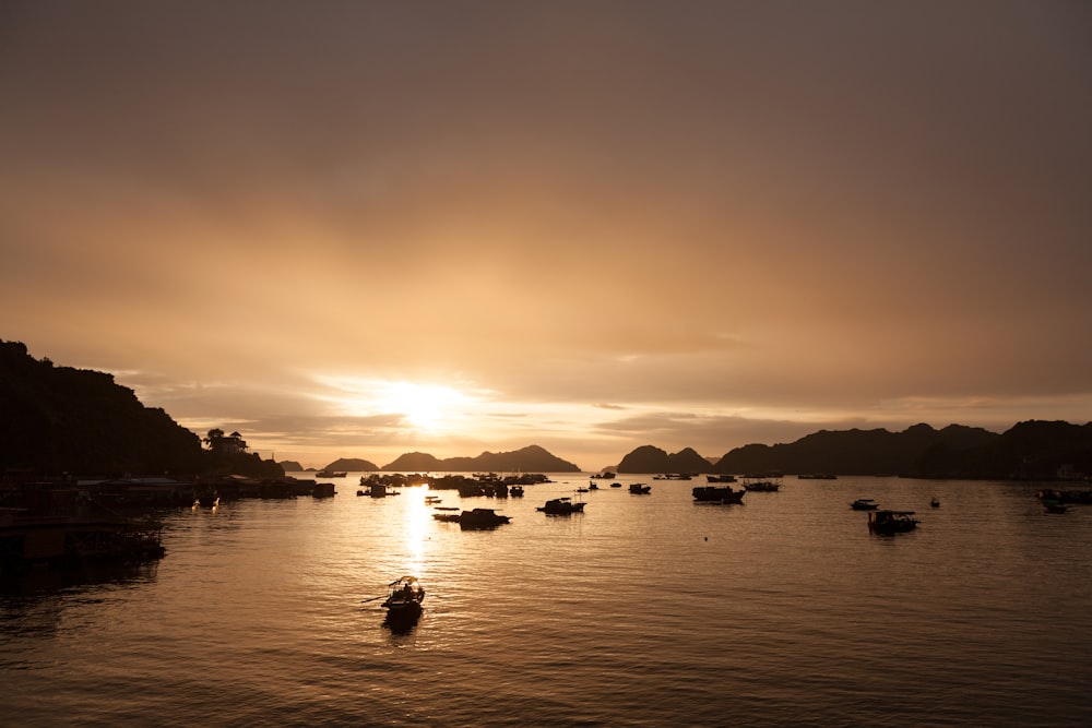 Barcos en el cuerpo de agua durante la puesta del sol
