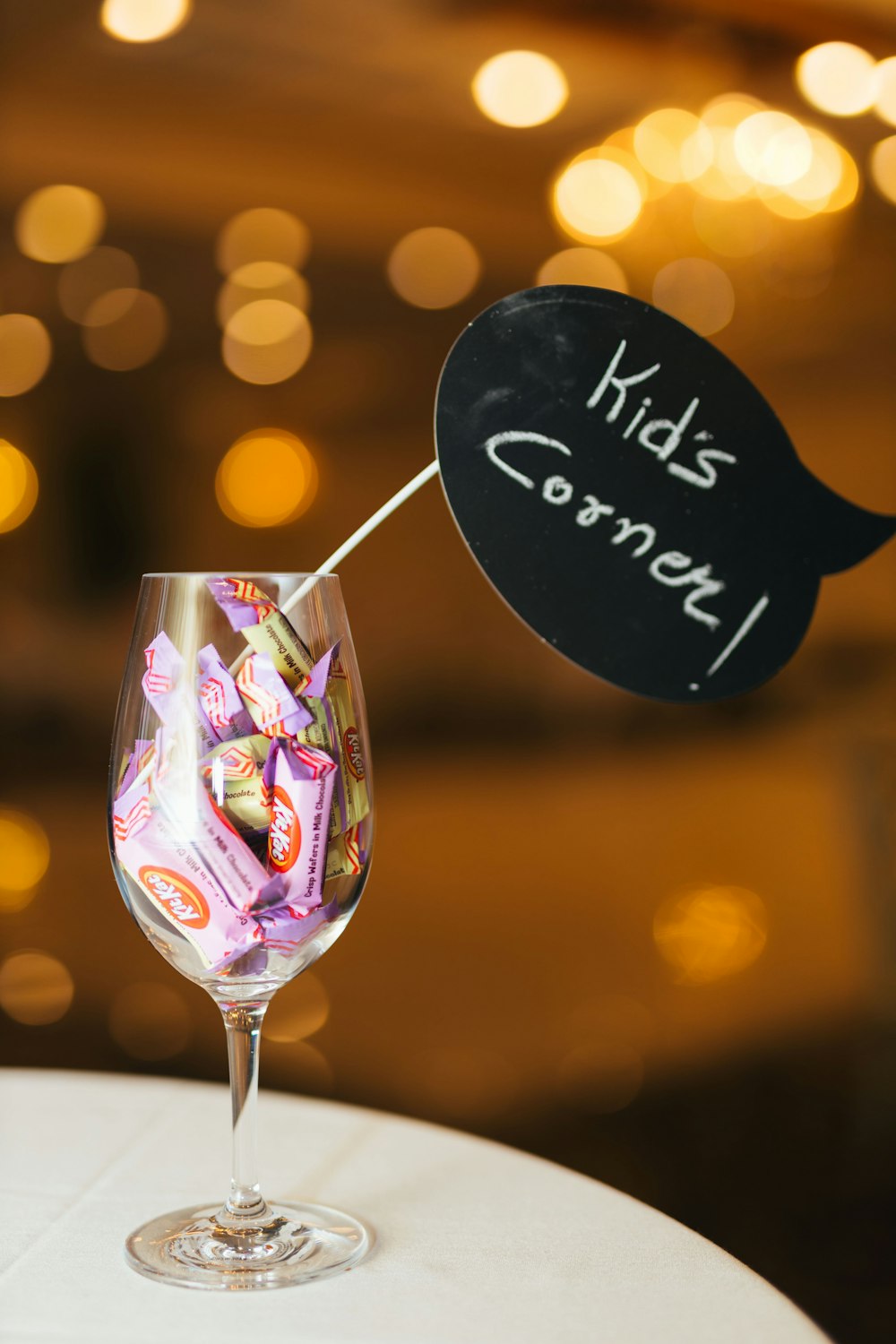 clear wine glass with Kid's Corner sign