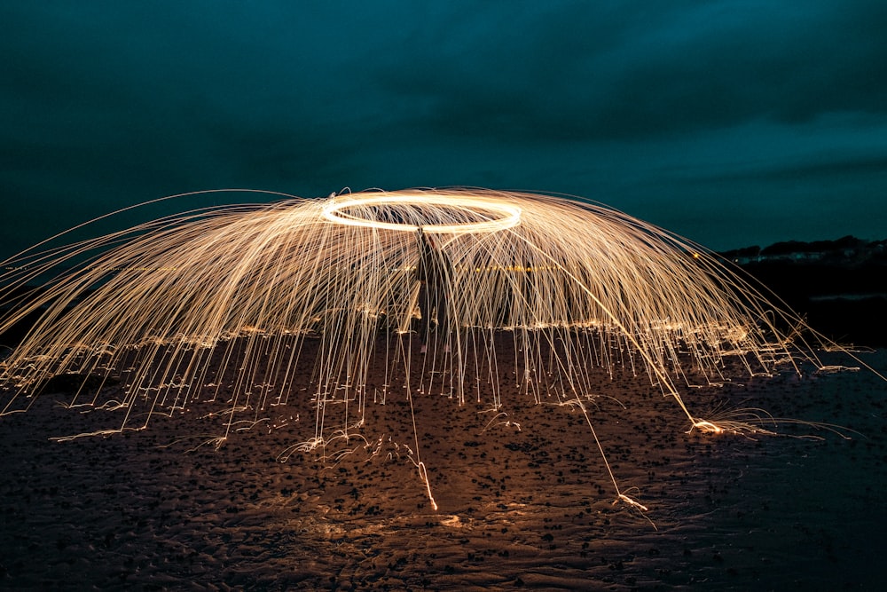 person holding firecracker during nighttime