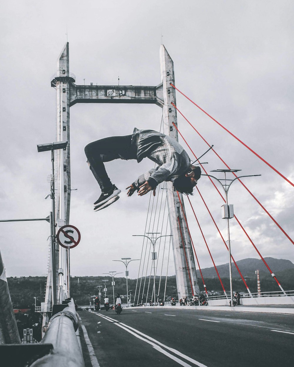 Hombre en chaqueta y pantalones en puente de hormigón