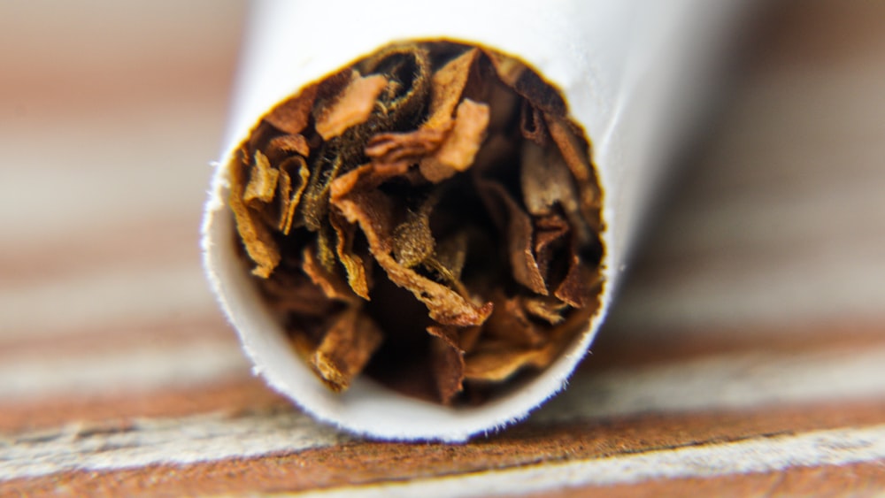 a close up of a white tube of cigarettes