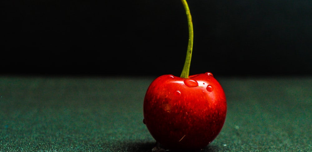 red cheery on green surface