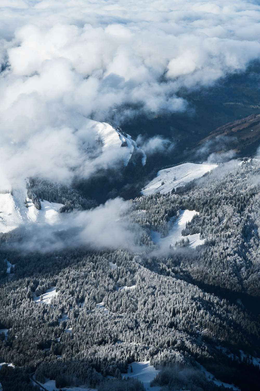 grayscale photography of land under white clouds