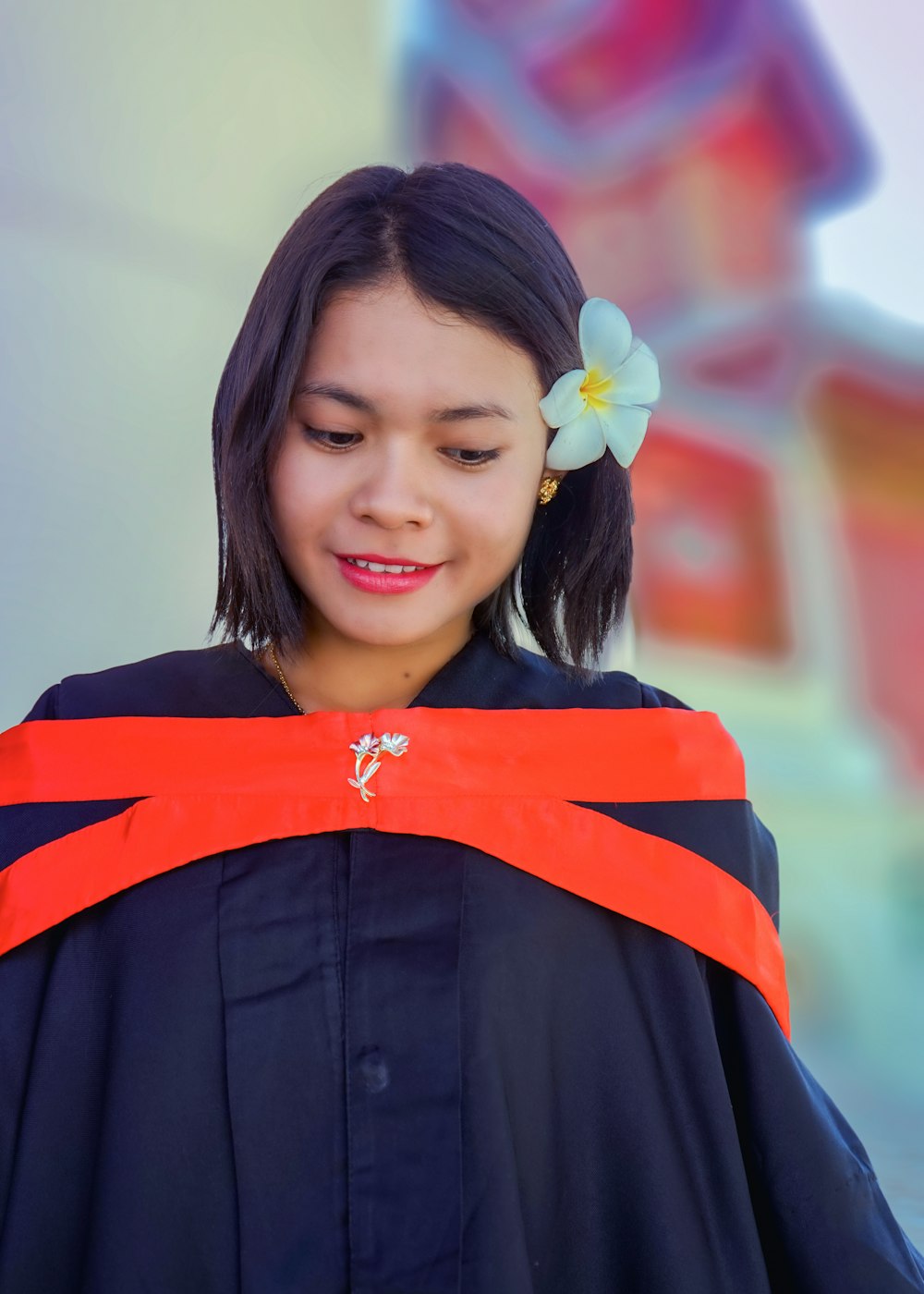 unknown person wearing academic dress taking selfie outdoors