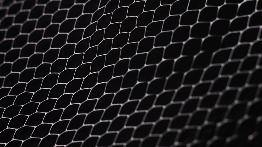 a black and white photo of a metal mesh