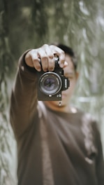 man holding Sony DSLR camera