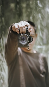 man holding Sony DSLR camera