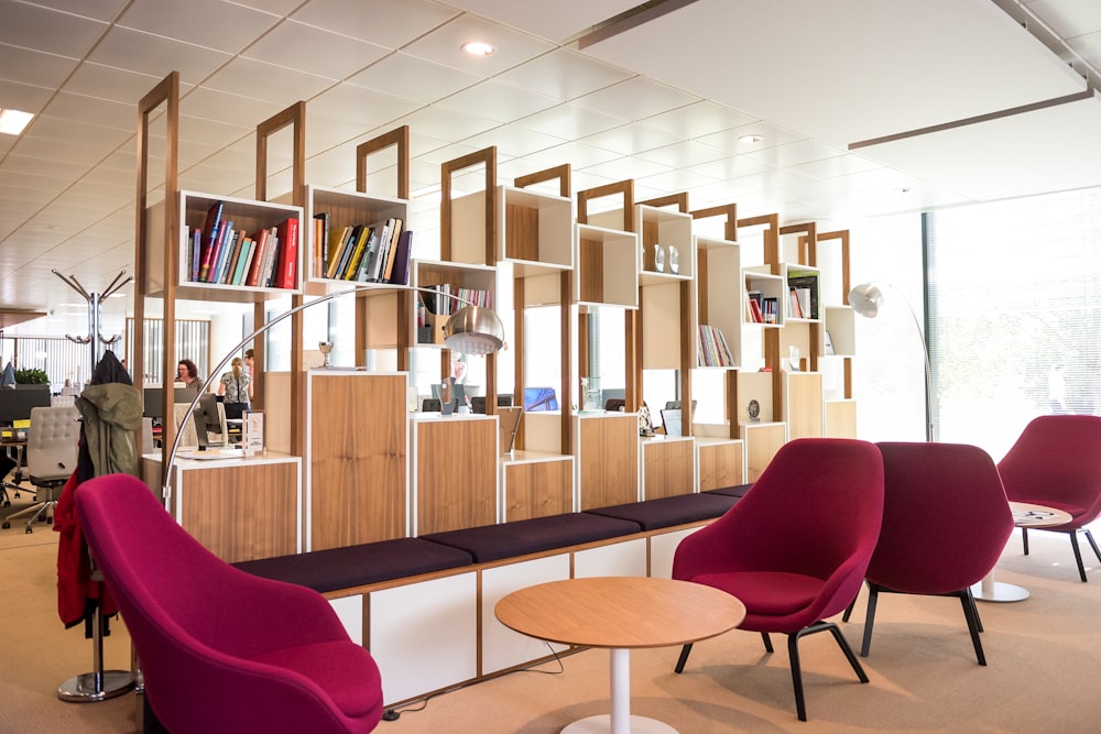 a room filled with lots of furniture and bookshelves