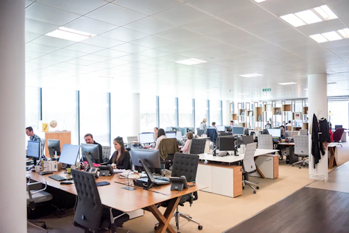 people working at desks in open office