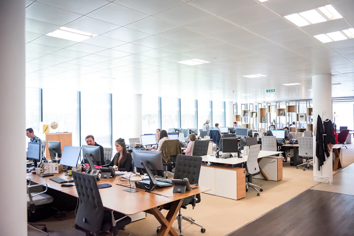 Technical support team assisting clients at workstations