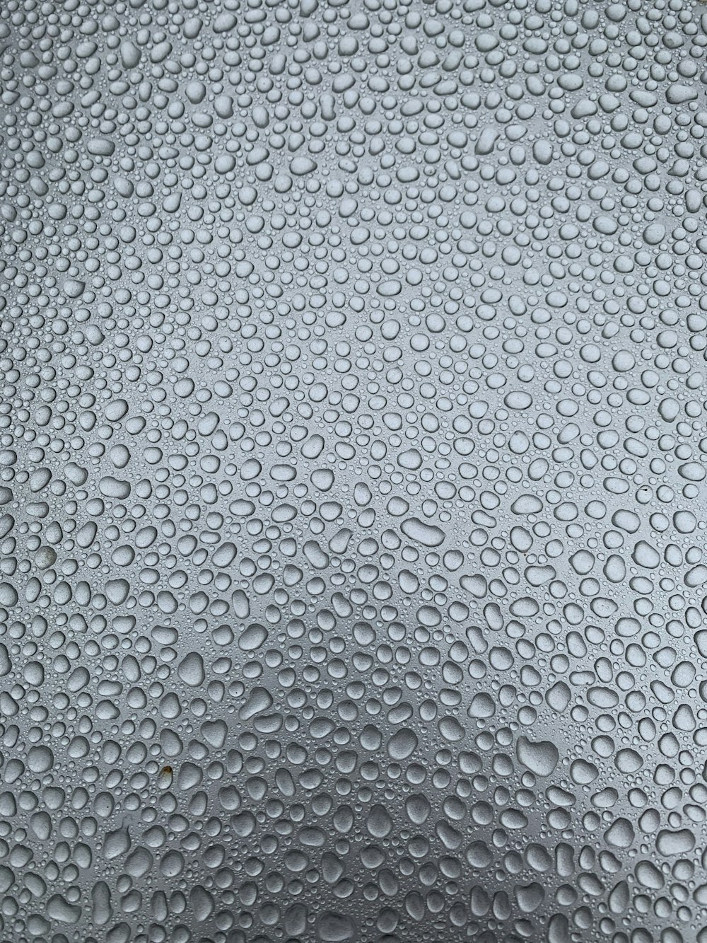 a close up of water droplets on a glass surface