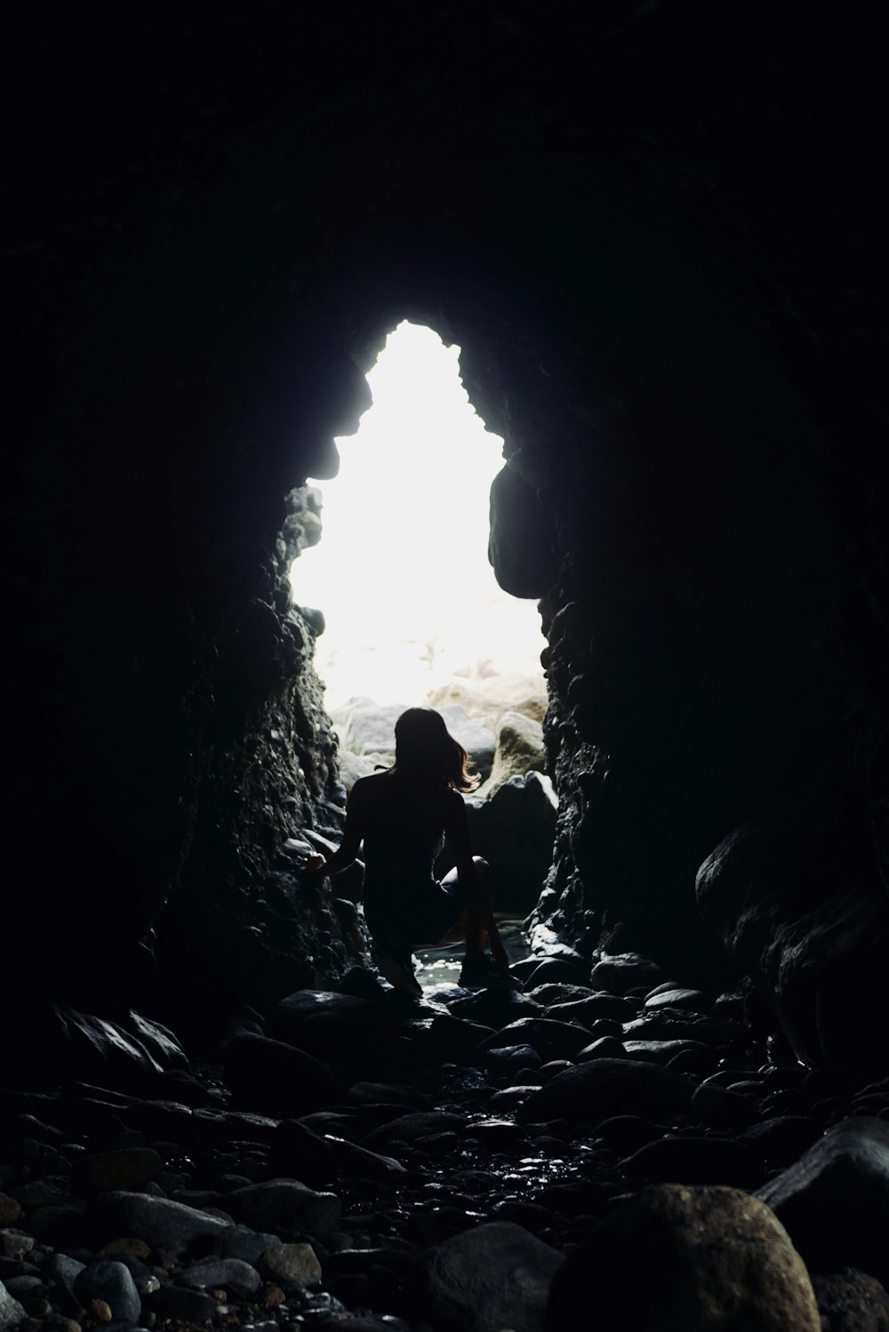 silhouette of person on tunnel