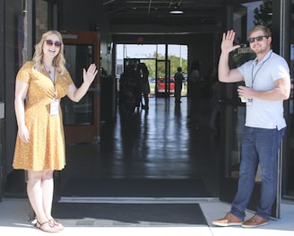 two man and woman standing on doorway