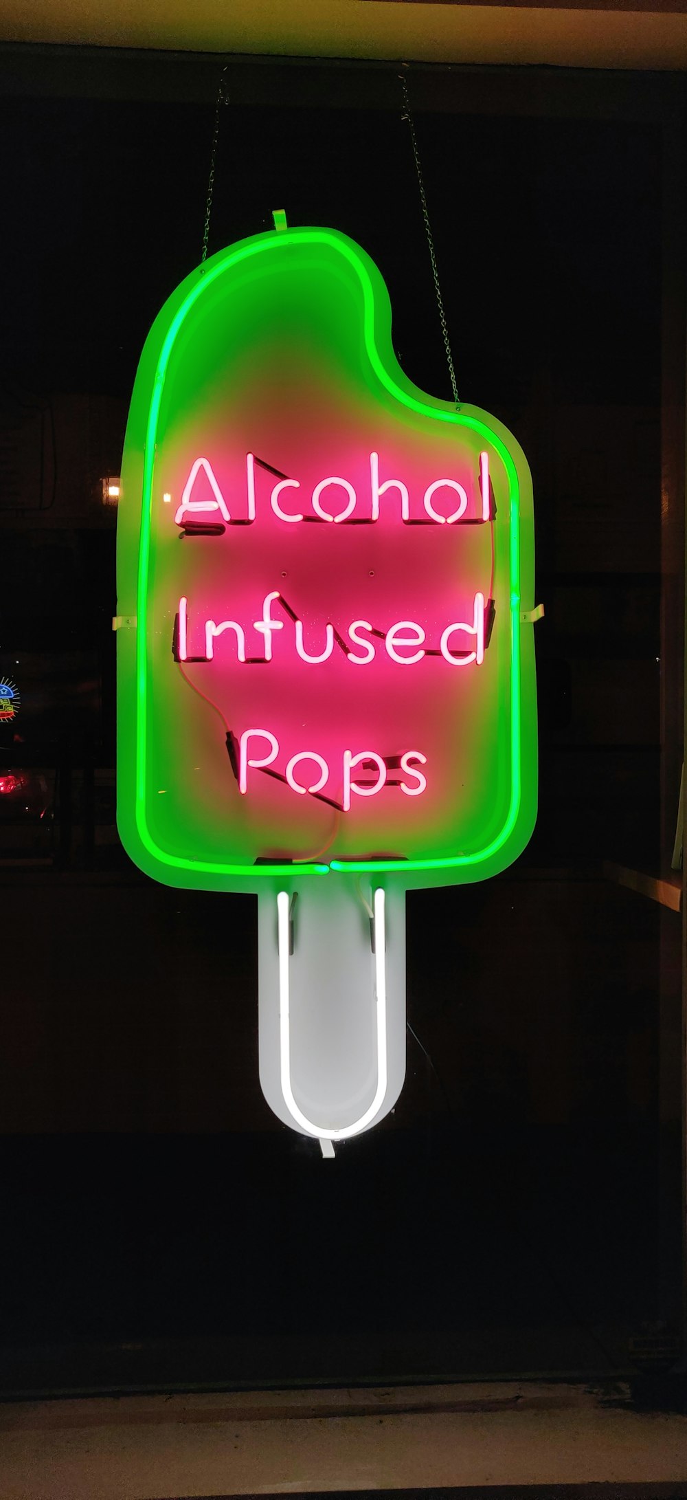 pink alcohol infused pops neon signage
