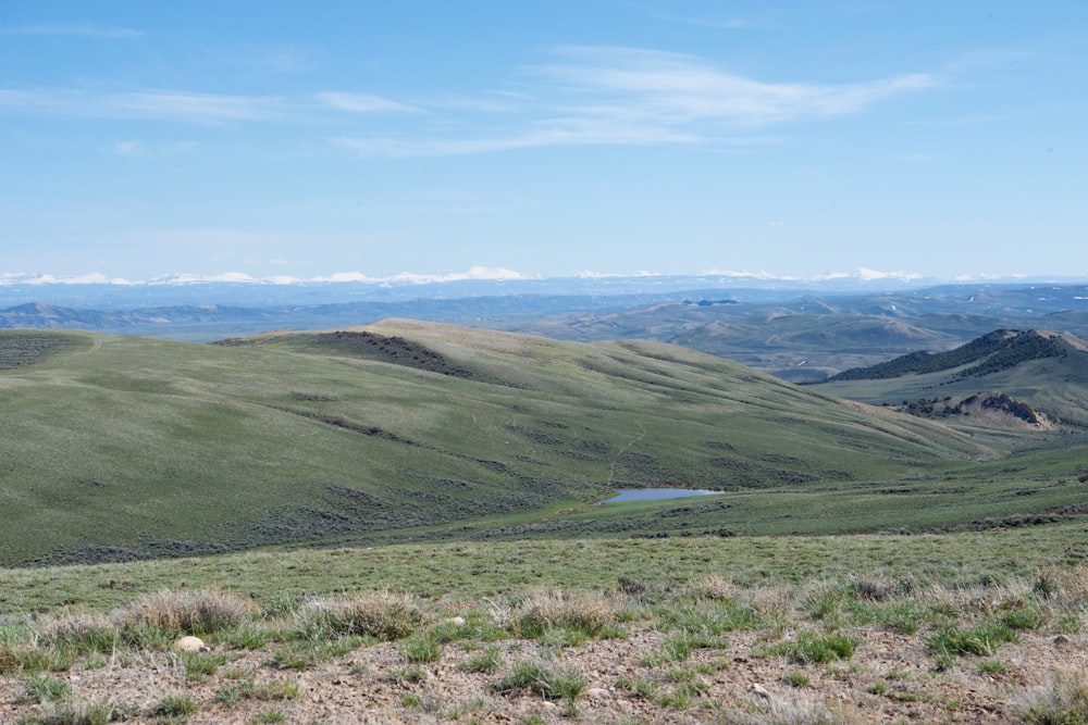 green hills under blue sky