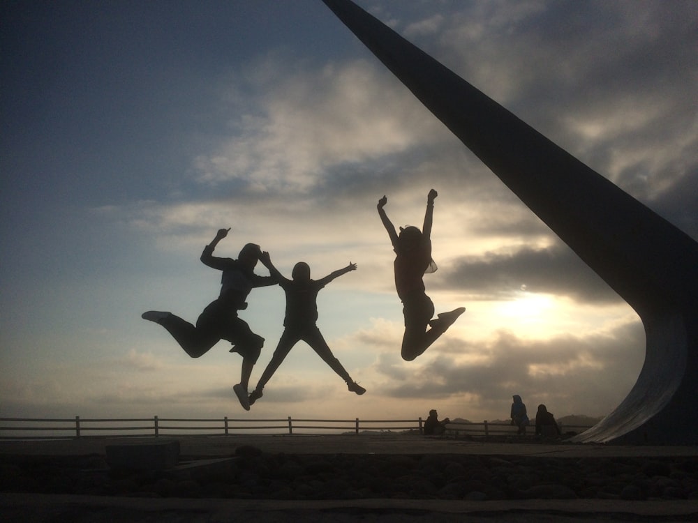 three jumping people