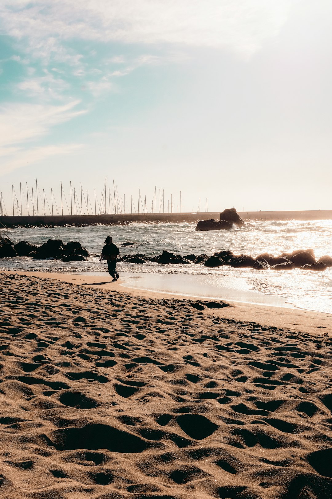 person standing on seashore during daytime