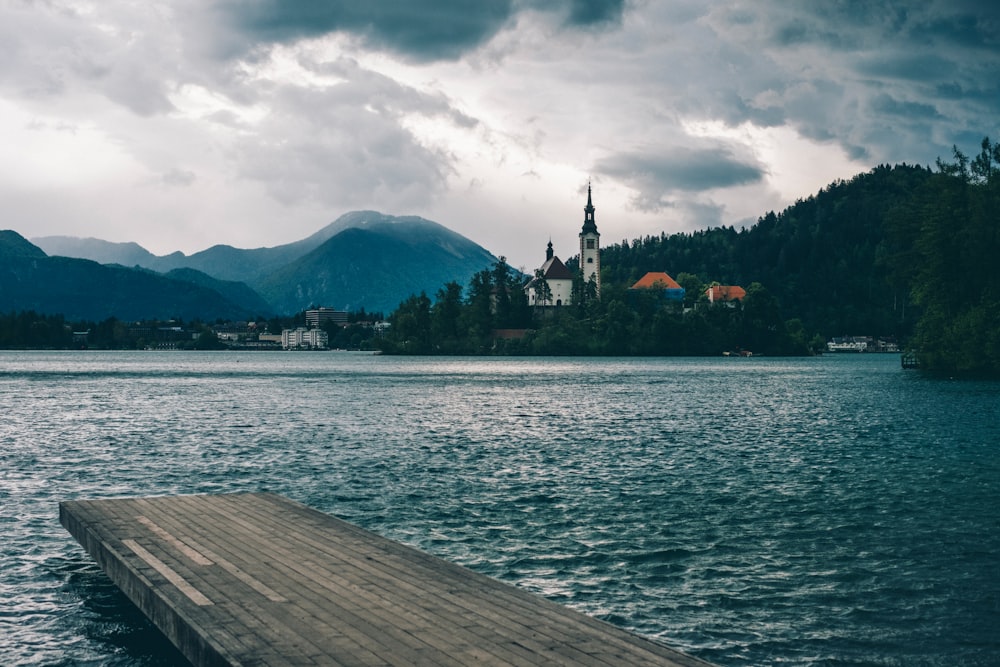 brown wooden dock on body of water