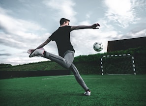 man playing soccer during daytime