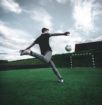 man playing soccer during daytime