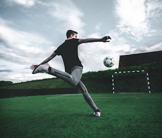 man playing soccer during daytime