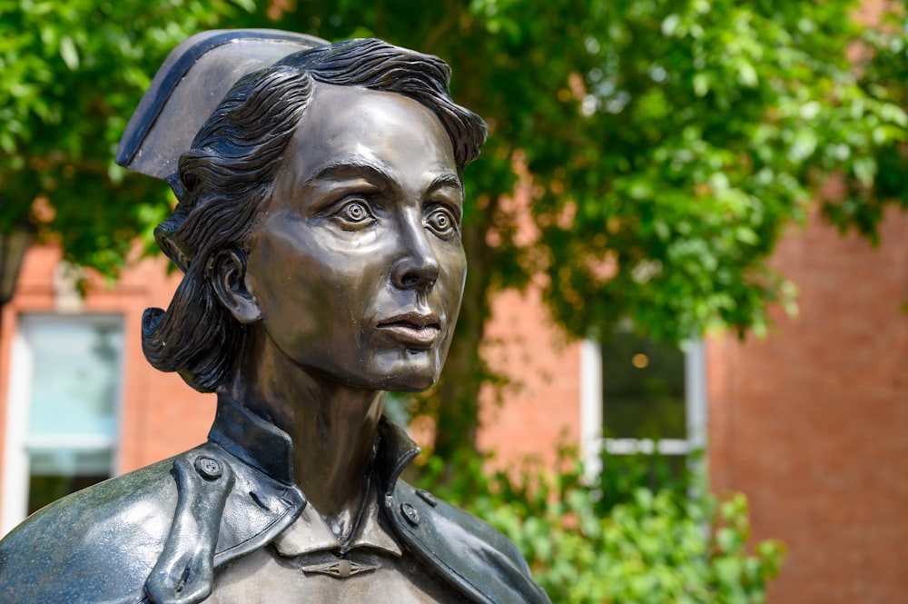 selective focus photography of woman statue