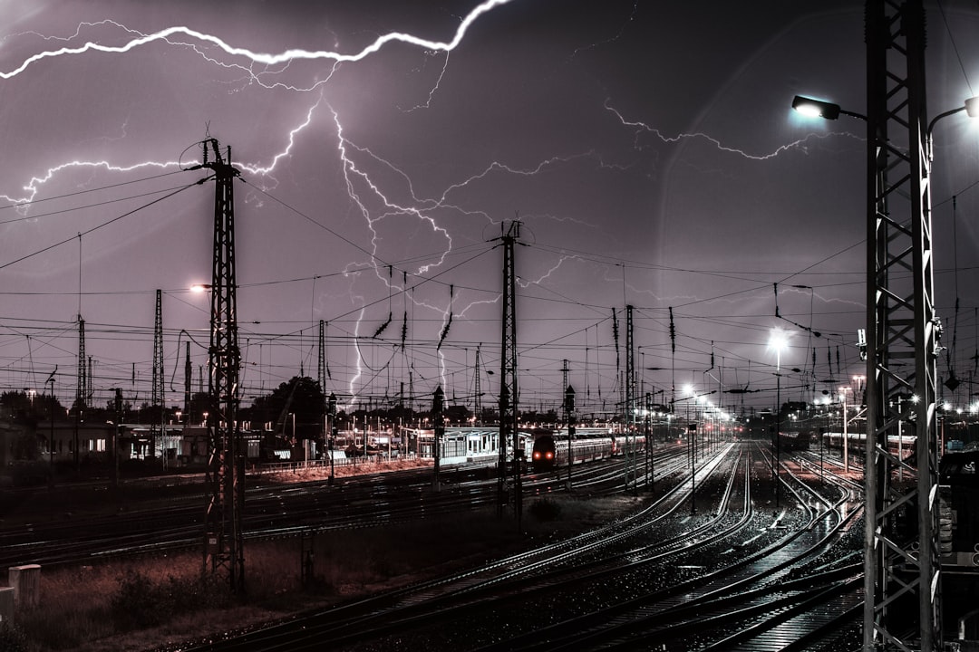 lightning during nightime, Thunderstorm / lightning over railroad station