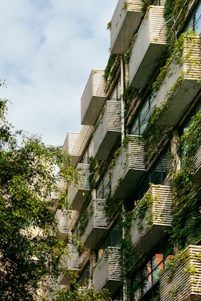 The elegant facade of Runwal Sanctuary with balconies overlooking green spaces.