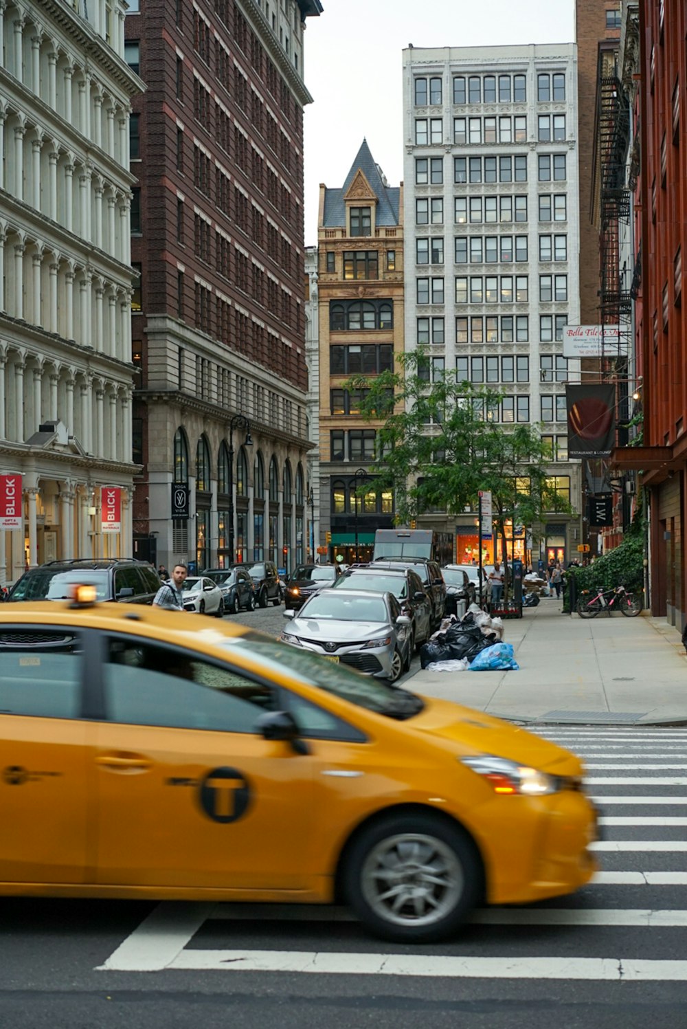 yellow taxi across city building