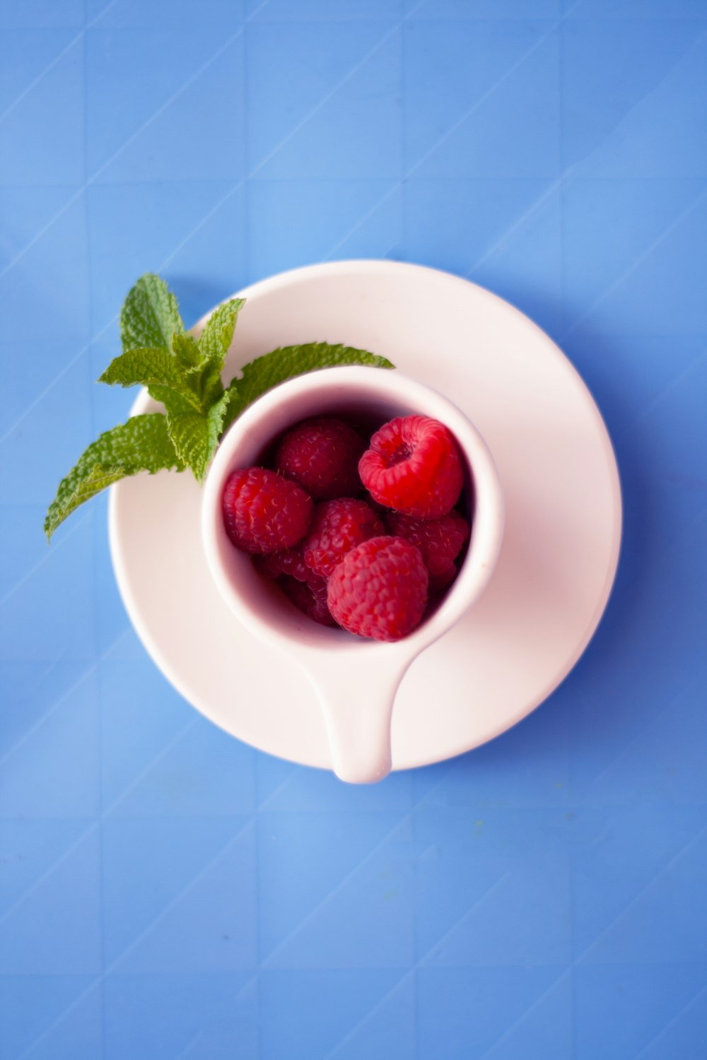 red raspberries on mug