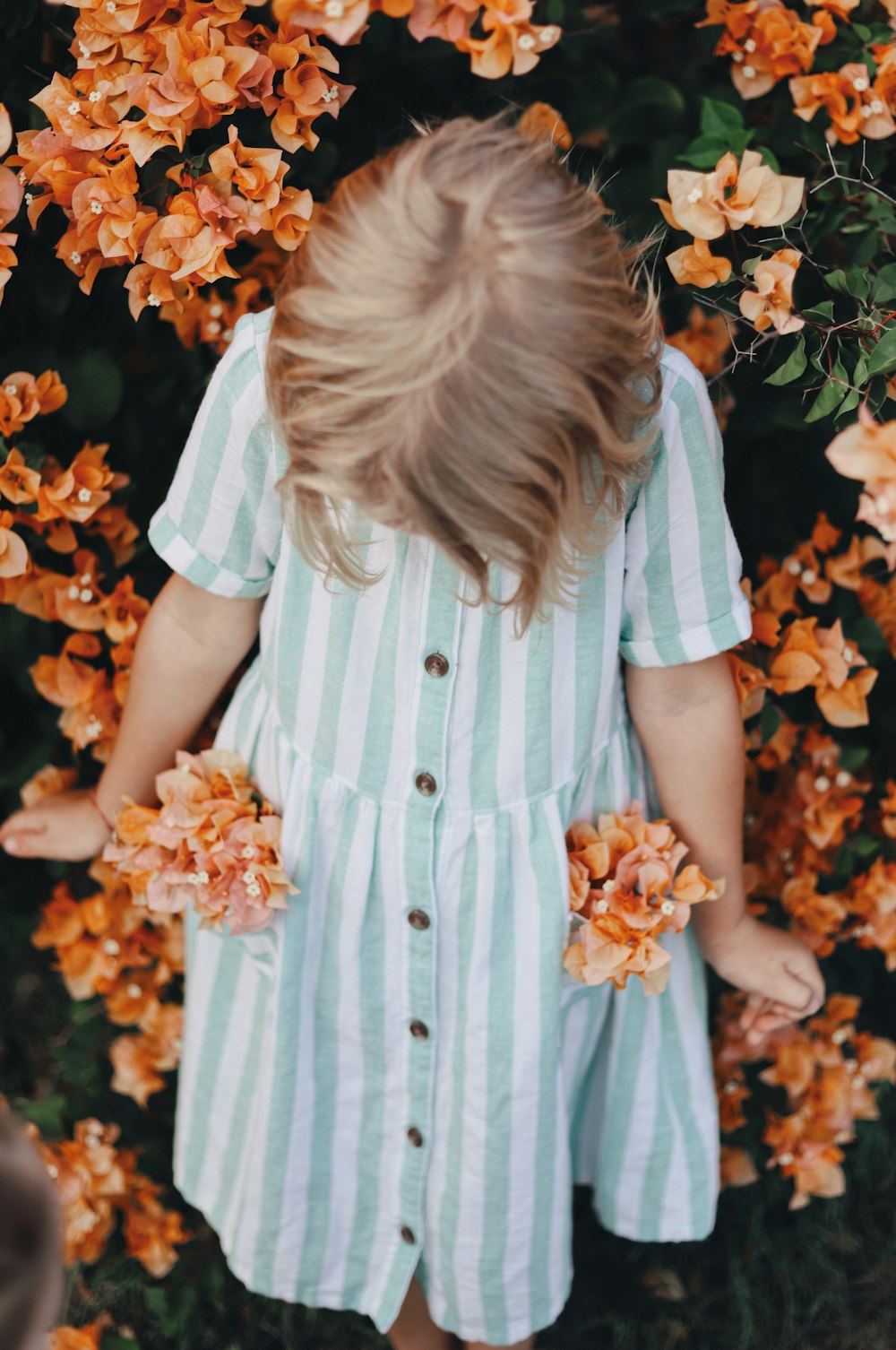 girl wearing teal and white striped dress