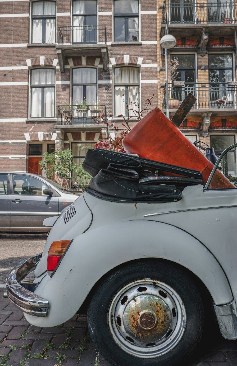 white car parked beside house