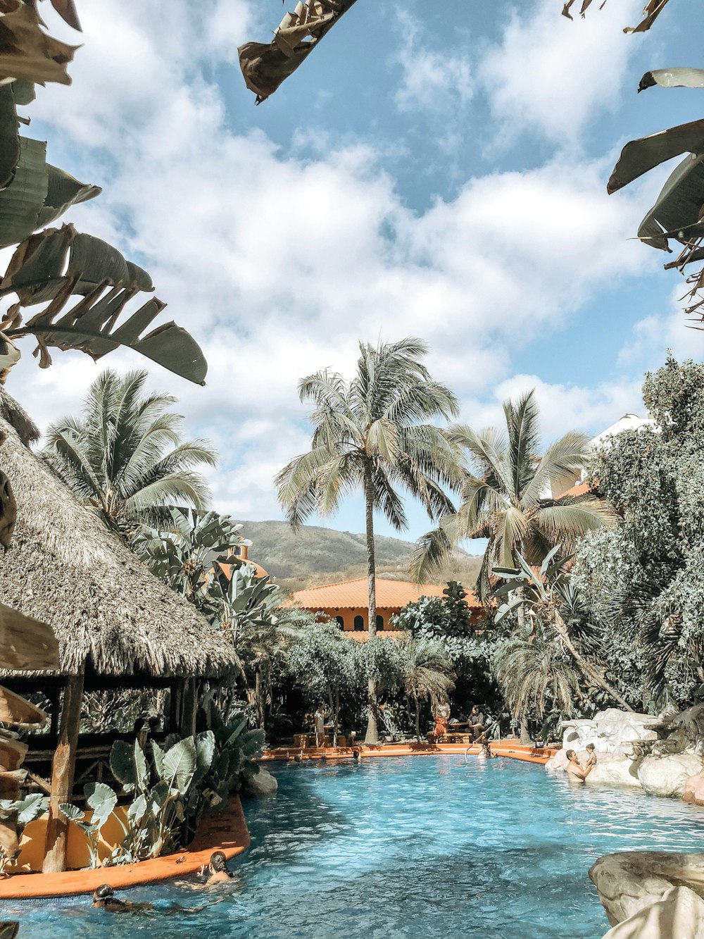 people in pool near hut