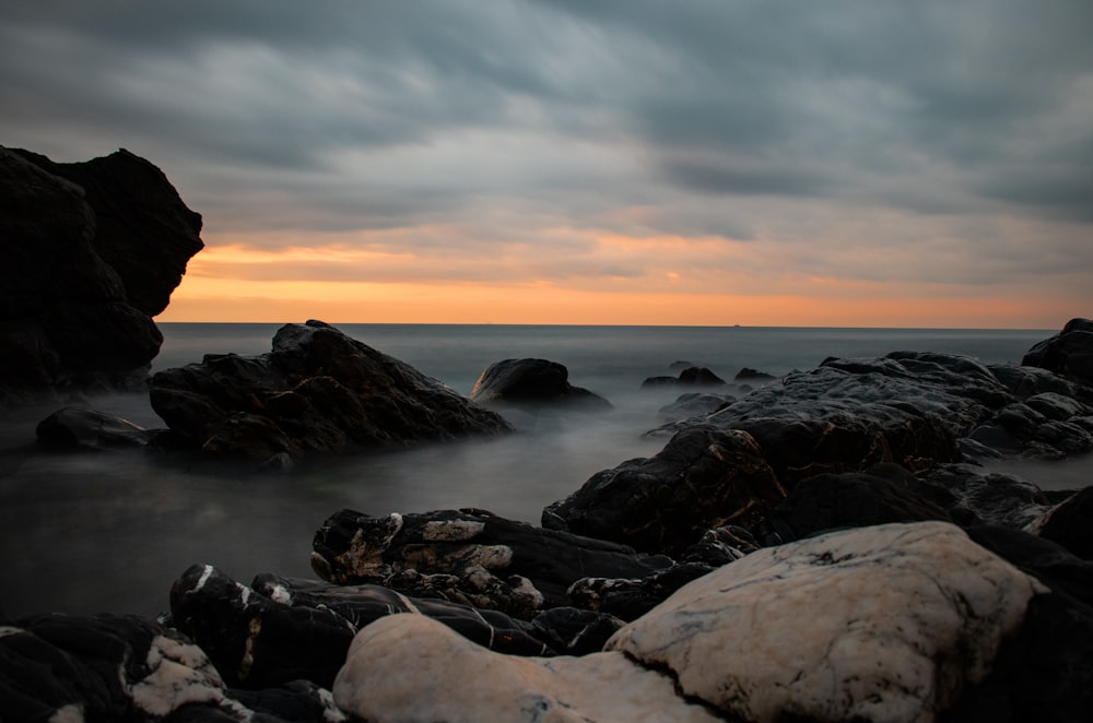 rocks under cloudy sky