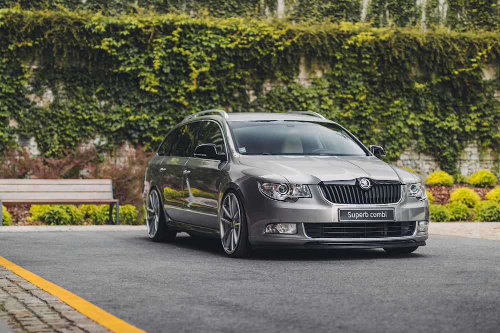 gray Peugeot sedan parking near road