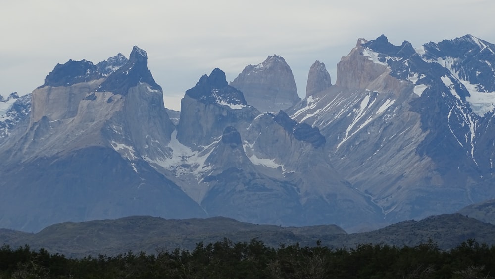 white snow capped mountain peaks in horizon