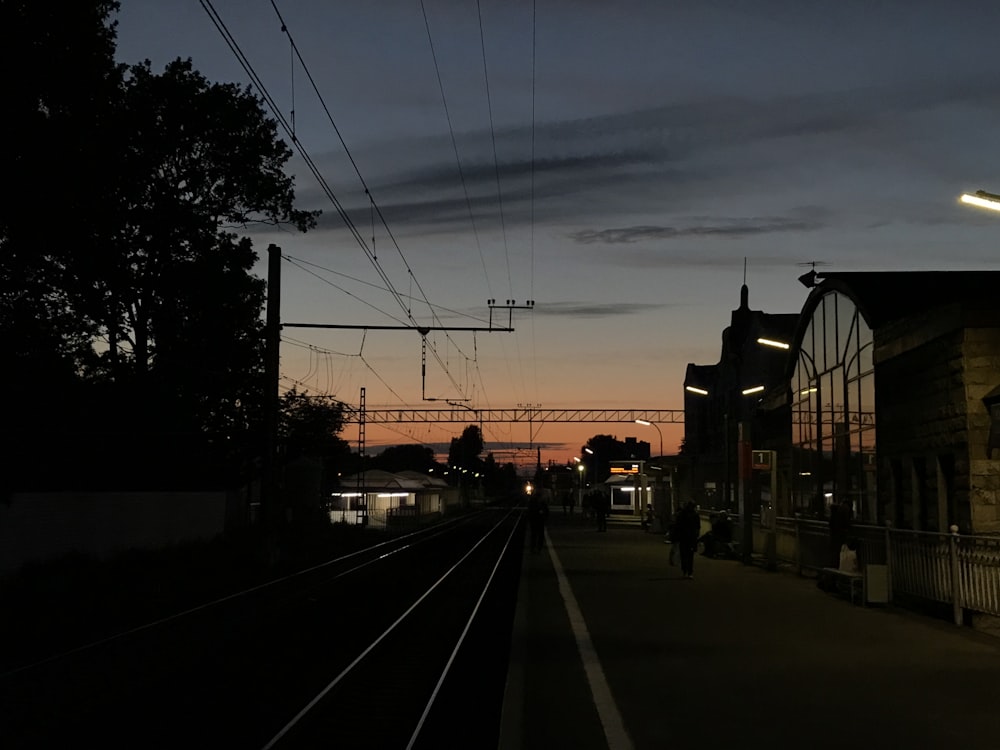 few people walking train station during night time