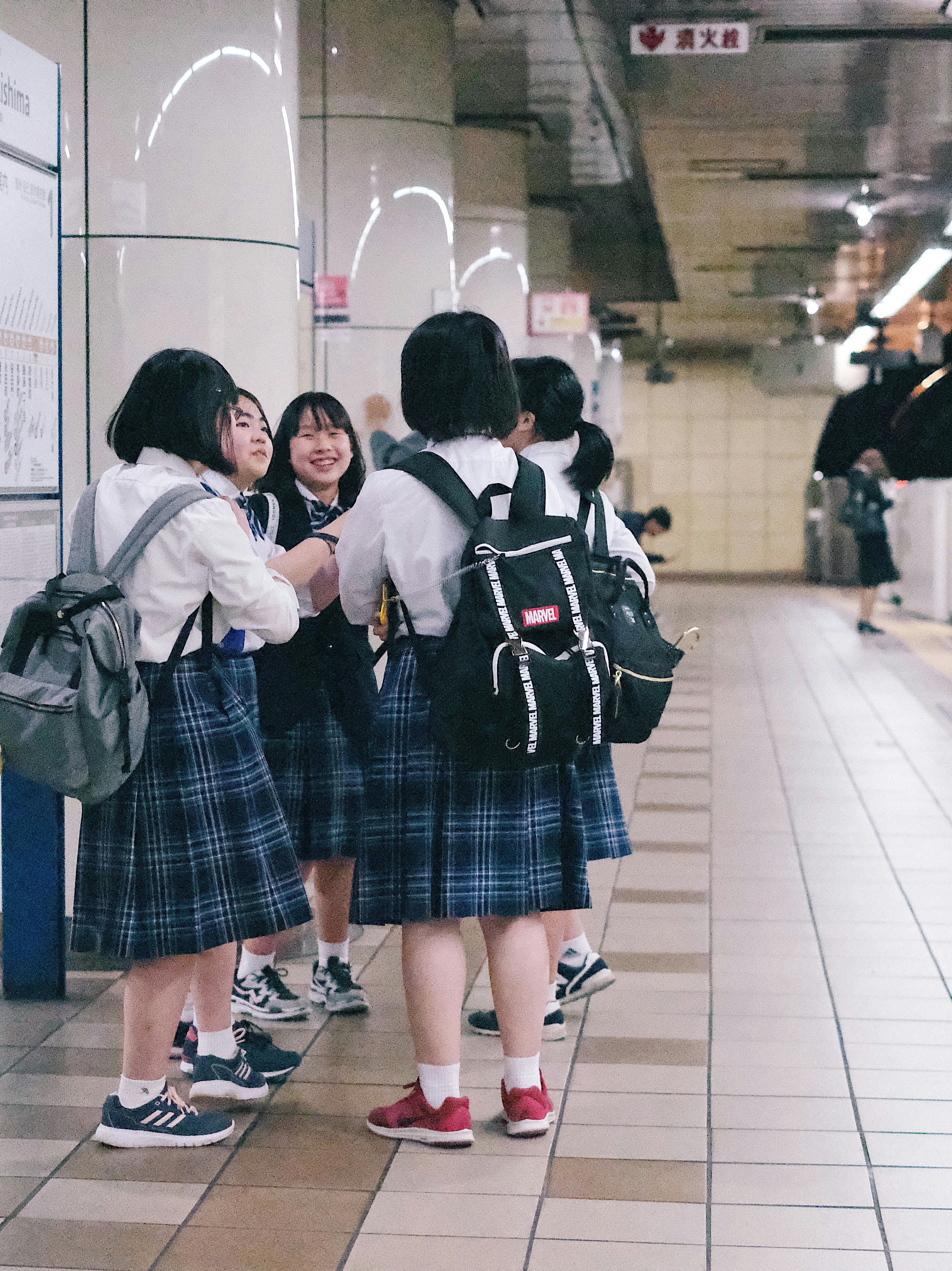 group of female students beside train railway