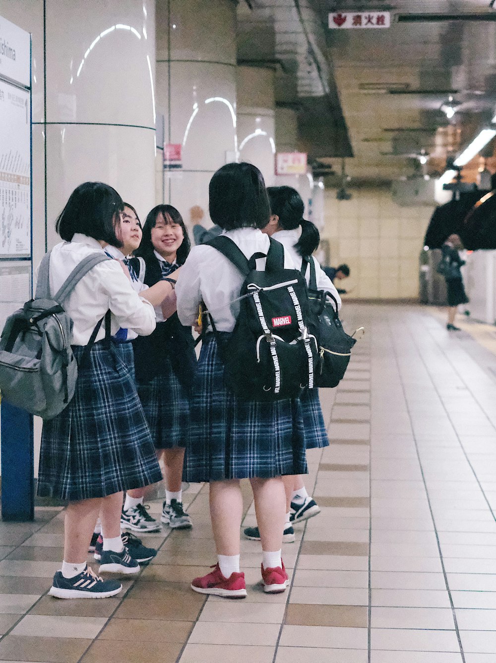 group of female students beside train railway