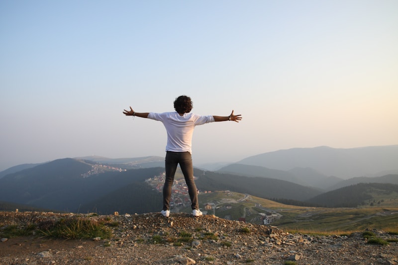 Man standing confidently on top of a hill