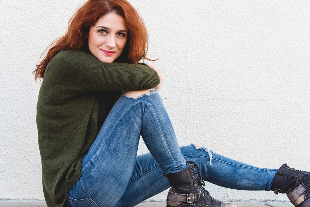 smiling woman in green sweater and bl