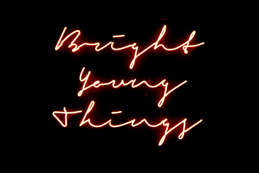 a red neon sign that says bright young things