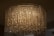 A large, ornate chandelier with numerous hanging crystal prisms that create a shimmering and luxurious effect. The lighting casts a warm, ambient glow, with intricate patterns created by the reflections and refractions of the crystals.