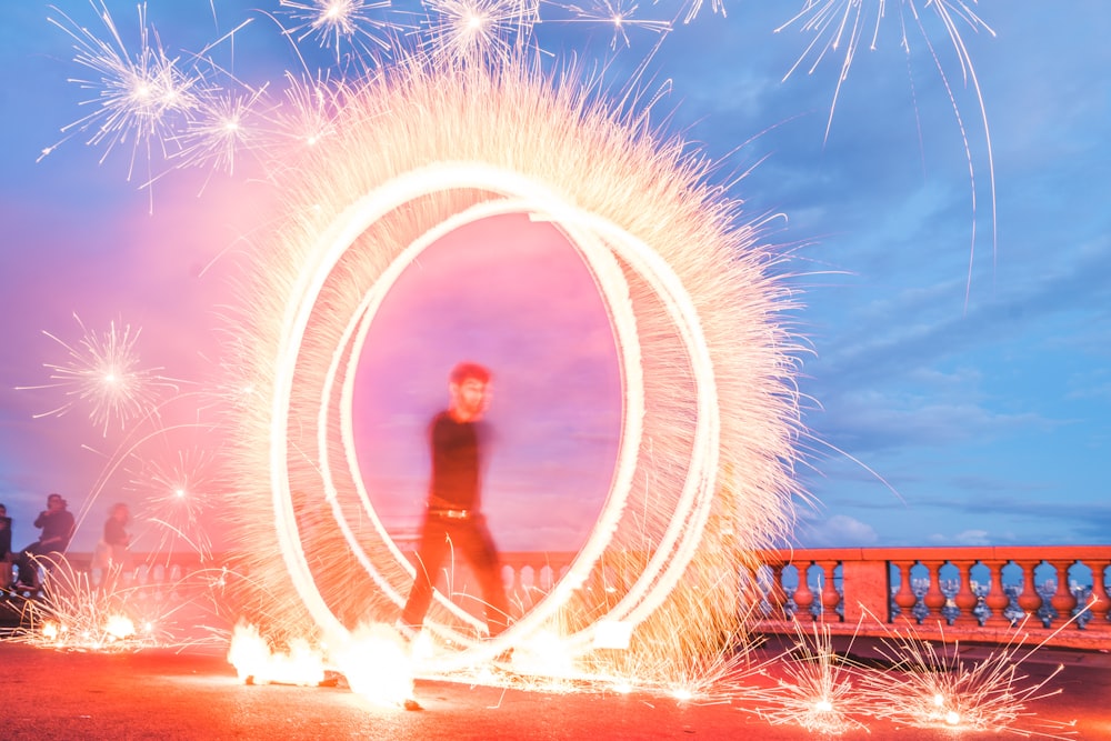 man with sparklers in park