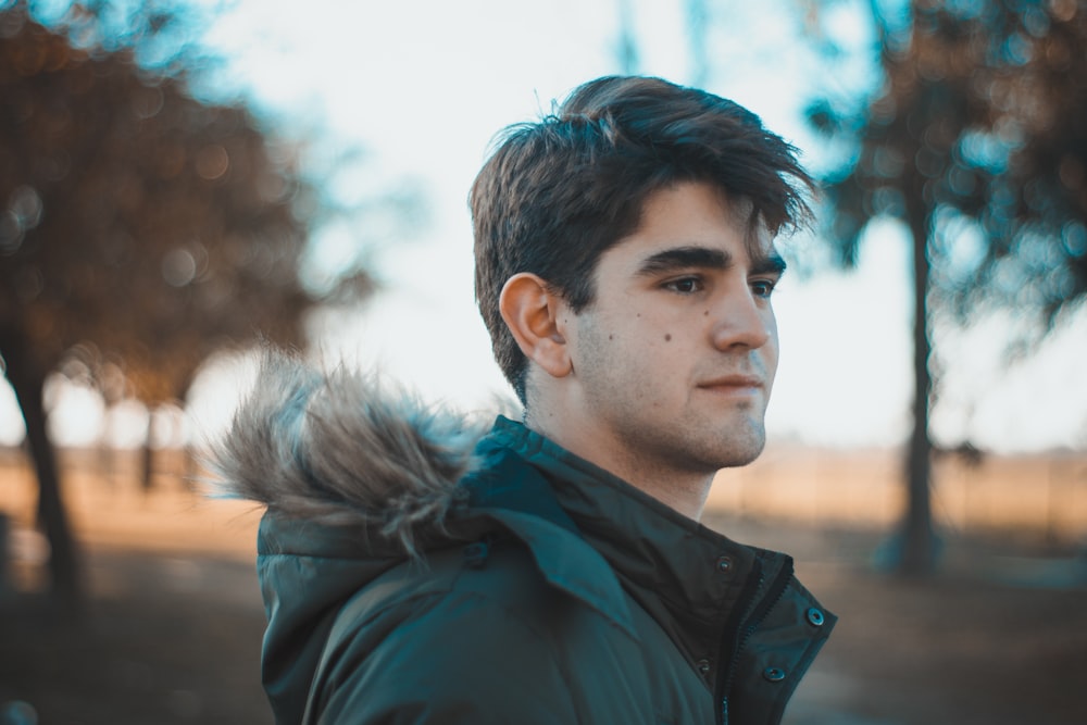 man in blue and black parka jacket